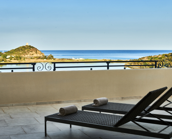 Patio with sun loungers and view of sea